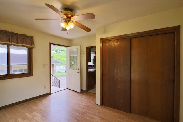 1217 Andover Ave, Eau Claire, WI 54703 - entryway with light wood finished floors, a ceiling fan, and baseboards