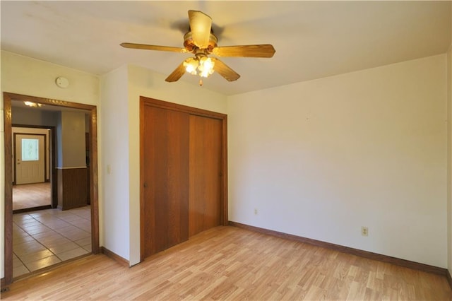 1217 Andover Ave, Eau Claire, WI 54703 - unfurnished bedroom featuring a closet, light wood-type flooring, baseboards, and a ceiling fan
