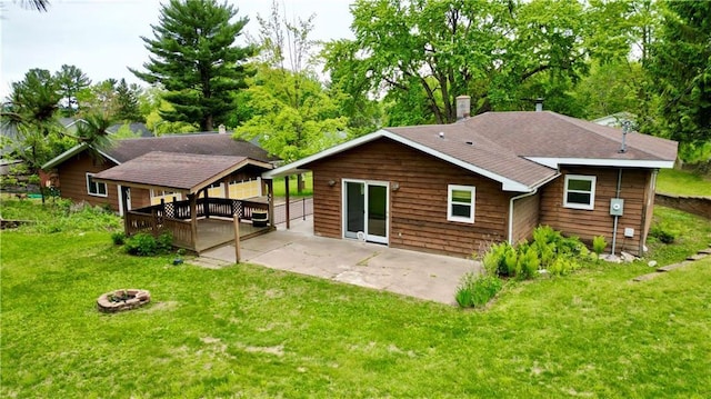 1217 Andover Ave, Eau Claire, WI 54703 - rear view of house featuring a fire pit, a yard, a patio, a chimney, and a deck