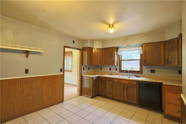 1217 Andover Ave, Eau Claire, WI 54703 - kitchen featuring black dishwasher, a sink, a wainscoted wall, light countertops, and brown cabinets