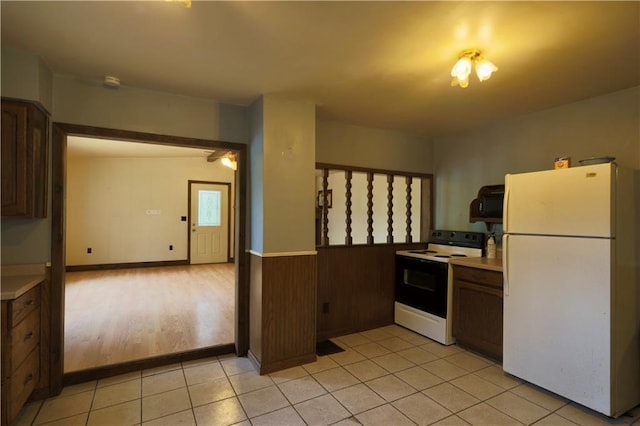 1217 Andover Ave, Eau Claire, WI 54703 - kitchen with freestanding refrigerator, electric range, light countertops, a wainscoted wall, and light tile patterned floors