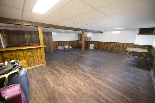 6538 N Bethmaur Ln, Glendale, WI 53209 - basement featuring a paneled ceiling, wood finished floors, wood walls, a dry bar, and a wainscoted wall