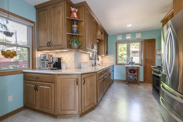 5744 W Rita Dr, West Allis, WI 53219 - kitchen featuring stainless steel appliances, a sink, open shelves, backsplash, and light countertops