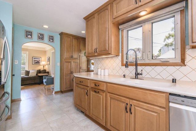 5744 W Rita Dr, West Allis, WI 53219 - kitchen featuring appliances with stainless steel finishes, arched walkways, light countertops, decorative backsplash, and recessed lighting