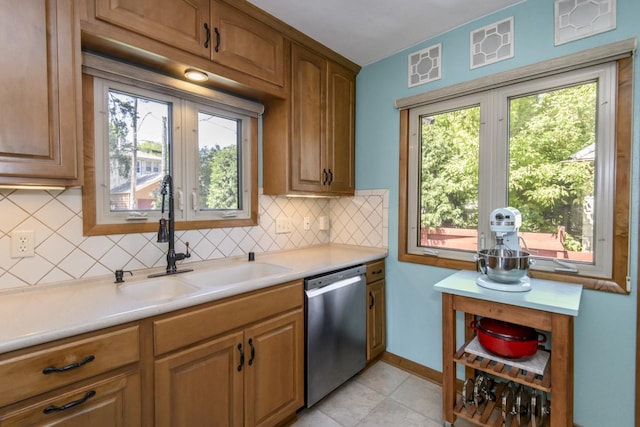 5744 W Rita Dr, West Allis, WI 53219 - kitchen featuring dishwasher, a sink, light countertops, backsplash, and healthy amount of natural light