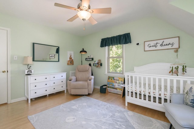 5744 W Rita Dr, West Allis, WI 53219 - bedroom featuring wood finished floors, a nursery area, and a ceiling fan