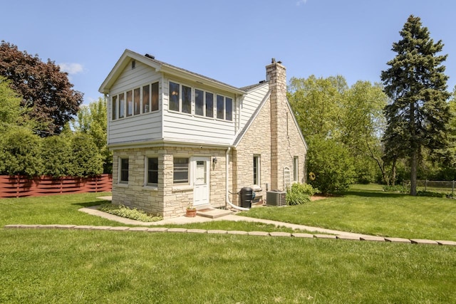 5744 W Rita Dr, West Allis, WI 53219 - view of front facade with stone siding, a chimney, and central air condition unit