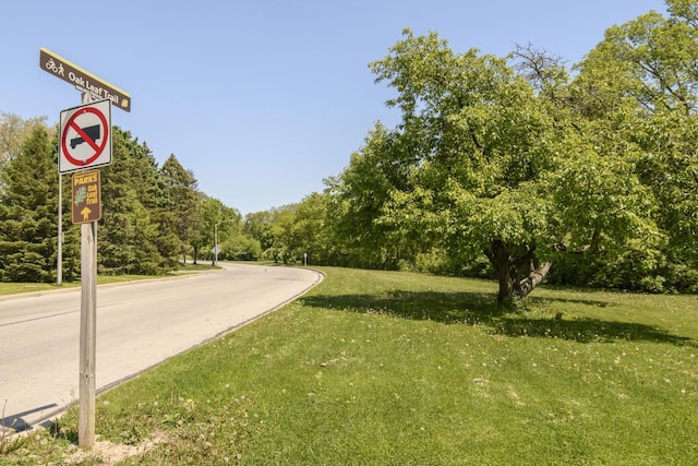5744 W Rita Dr, West Allis, WI 53219 - view of asphalt road featuring traffic signs
