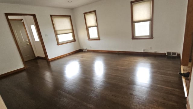 2210 Taylor Ave, Racine, WI 53403 - empty room featuring dark wood finished floors and baseboards