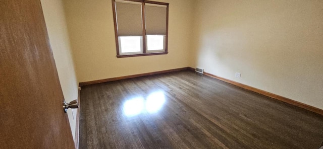 2210 Taylor Ave, Racine, WI 53403 - empty room featuring dark wood finished floors and baseboards