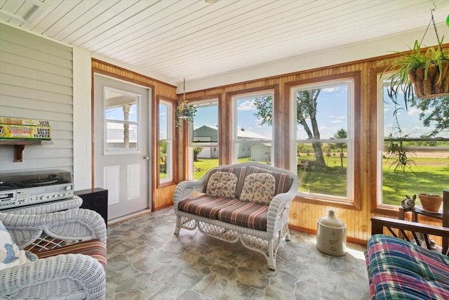 W7211 Pine Rd, Thorp, WI 54771 - sunroom / solarium featuring stone floors, healthy amount of natural light, wooden walls, and wood ceiling