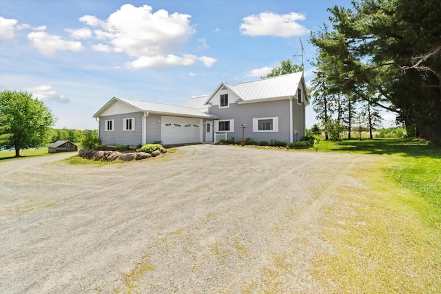 W7211 Pine Rd, Thorp, WI 54771 - view of front of home with driveway, an attached garage, and metal roof