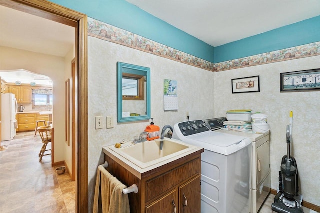 W7211 Pine Rd, Thorp, WI 54771 - laundry area with washing machine and clothes dryer, a sink, and baseboards