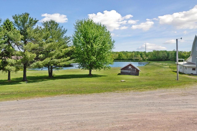 W7211 Pine Rd, Thorp, WI 54771 - view of home's community with a lawn, a water view, and an outbuilding