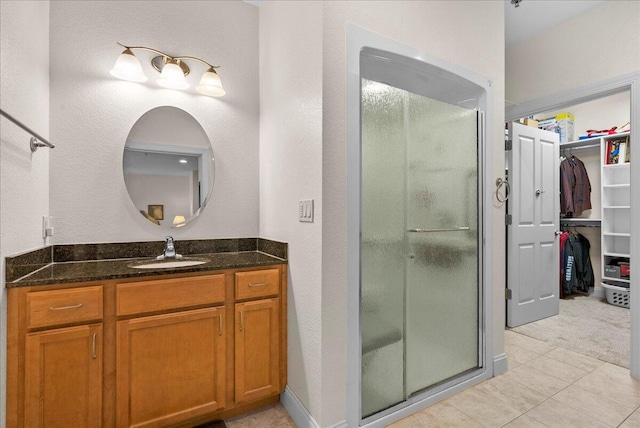 832 N 6th St Unit 118, Sheboygan, WI 53081 - full bath featuring a shower stall, vanity, a walk in closet, and tile patterned floors