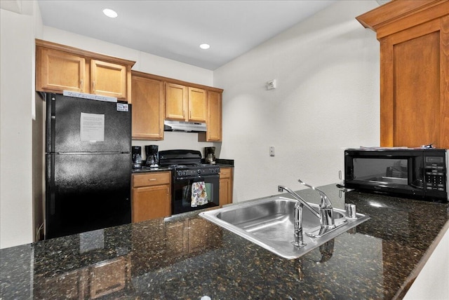 832 N 6th St Unit 118, Sheboygan, WI 53081 - kitchen featuring black appliances, under cabinet range hood, a sink, brown cabinets, and dark stone counters