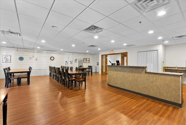 832 N 6th St Unit 118, Sheboygan, WI 53081 - dining room featuring wood finished floors, a drop ceiling, and baseboards