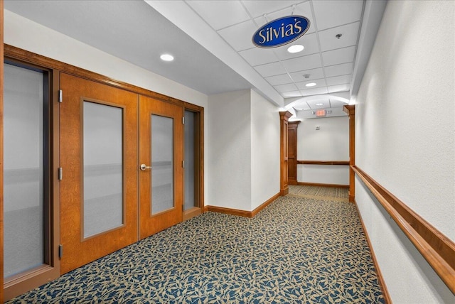 832 N 6th St Unit 118, Sheboygan, WI 53081 - hall featuring french doors, baseboards, recessed lighting, a paneled ceiling, and carpet flooring