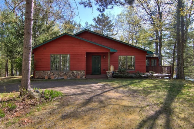 8360 W Shore Ln, Hayward, WI 54843 - chalet / cabin with stone siding, a front yard, and a deck