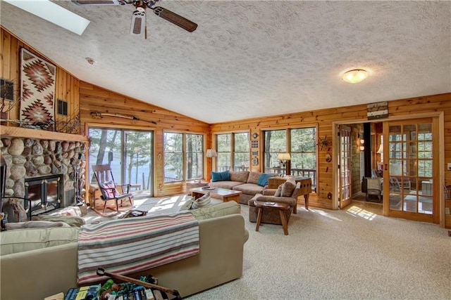 8360 W Shore Ln, Hayward, WI 54843 - living room featuring wooden walls, plenty of natural light, ceiling fan, a textured ceiling, and lofted ceiling