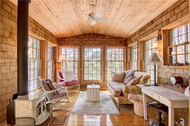 8360 W Shore Ln, Hayward, WI 54843 - living area with vaulted ceiling, a wood stove, a ceiling fan, hardwood / wood-style flooring, and wood ceiling