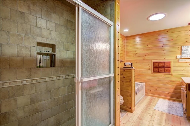 8360 W Shore Ln, Hayward, WI 54843 - full bathroom featuring vanity, a shower stall, wood-type flooring, toilet, and wood walls