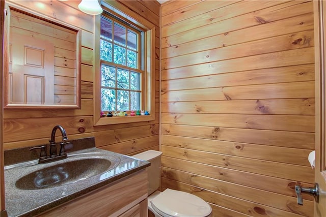 8360 W Shore Ln, Hayward, WI 54843 - bathroom with wooden walls, vanity, and toilet