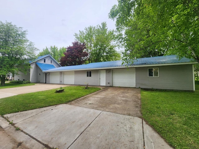 409 W Spence St, Colby, WI 54421 - ranch-style home with an attached garage, concrete driveway, a front yard, and metal roof