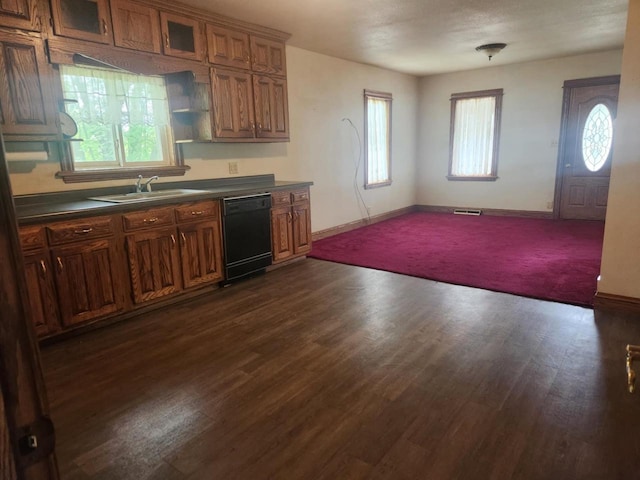 409 W Spence St, Colby, WI 54421 - kitchen featuring black dishwasher, a sink, dark countertops, and baseboards
