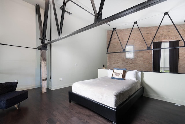 3059 N Weil St Unit 124, Milwaukee, WI 53212 - bedroom featuring baseboards, wood finished floors, and brick wall