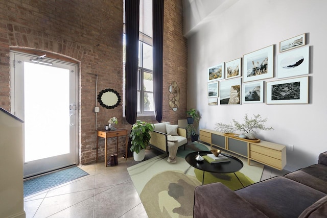 3059 N Weil St Unit 124, Milwaukee, WI 53212 - living area with brick wall, a high ceiling, and tile patterned flooring