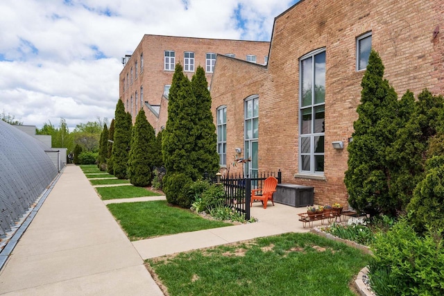 3059 N Weil St Unit 124, Milwaukee, WI 53212 - view of side of property with brick siding and a yard