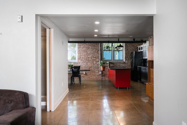 3059 N Weil St Unit 124, Milwaukee, WI 53212 - kitchen featuring dark countertops, plenty of natural light, freestanding refrigerator, and open floor plan
