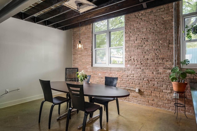 3059 N Weil St Unit 124, Milwaukee, WI 53212 - dining space featuring brick wall, tile patterned flooring, and beam ceiling