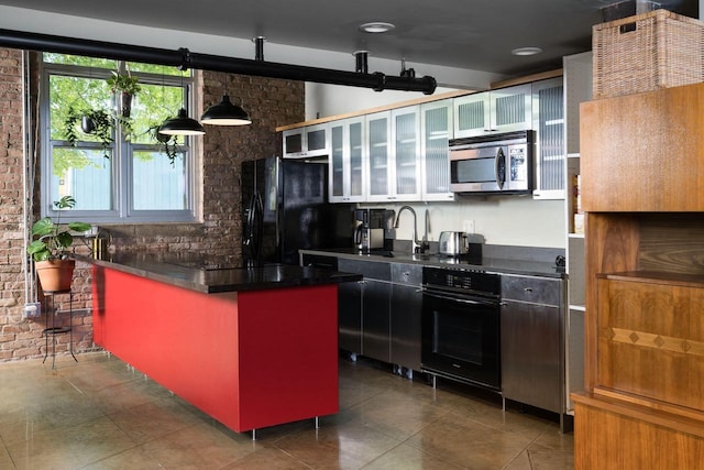 3059 N Weil St Unit 124, Milwaukee, WI 53212 - kitchen with black appliances, a sink, dark countertops, tile patterned flooring, and glass insert cabinets