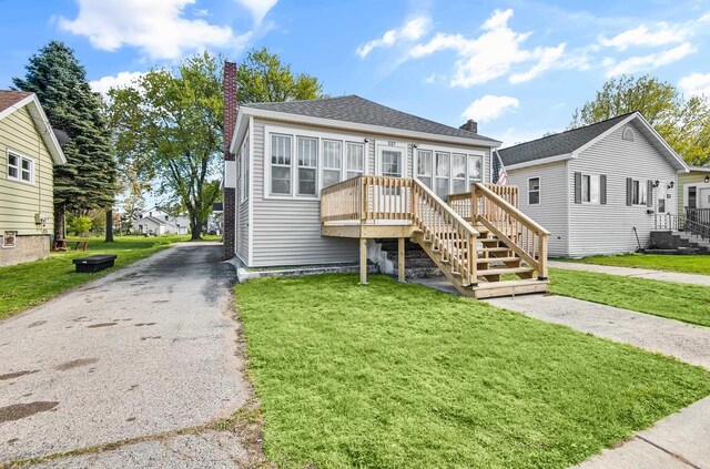 537 6th Ave, Menomonie, MI 49858 - view of front of house featuring a chimney, a front yard, and stairs