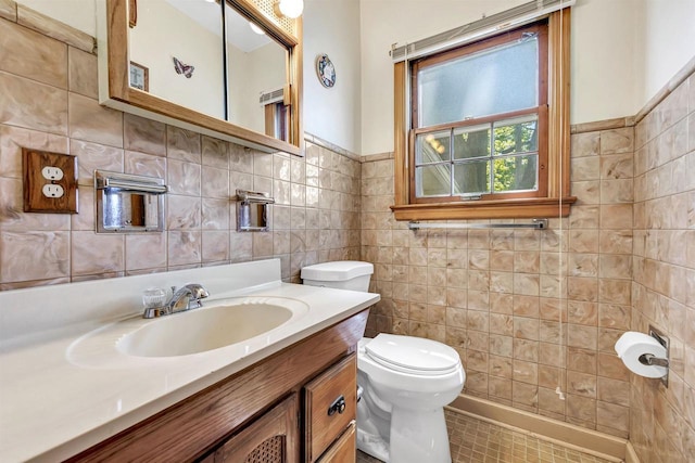 108 Healy Ct, Shawano, WI 54166 - bathroom featuring toilet, tile walls, vanity, and a wainscoted wall