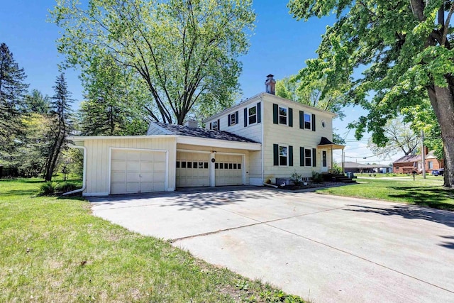 108 Healy Ct, Shawano, WI 54166 - view of front of property with a chimney, concrete driveway, a garage, and a front lawn