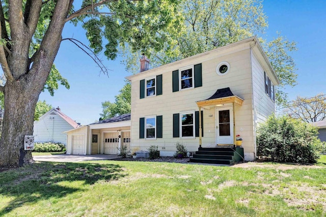 108 Healy Ct, Shawano, WI 54166 - colonial house featuring a garage, a chimney, a front yard, and driveway