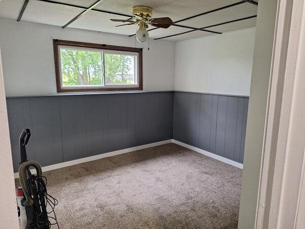 810 Railroad Ave, Viroqua, WI 54665 - spare room with a ceiling fan, carpet flooring, a wainscoted wall, and baseboards