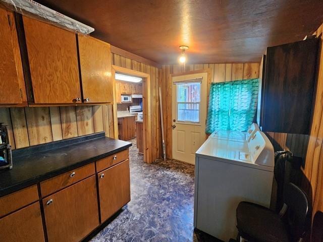 5183 2nd Ave, Pittsville, WI 54466 - kitchen featuring brown cabinets, wood walls, dark countertops, and white microwave