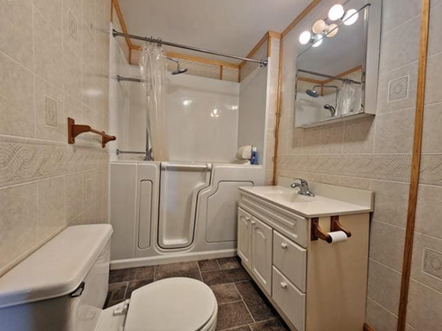 5183 2nd Ave, Pittsville, WI 54466 - bathroom featuring tile walls, toilet, vanity, and shower / tub combo