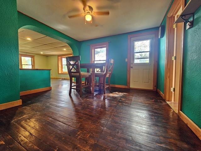 5183 2nd Ave, Pittsville, WI 54466 - dining space featuring arched walkways, ceiling fan, a textured wall, wood-type flooring, and baseboards