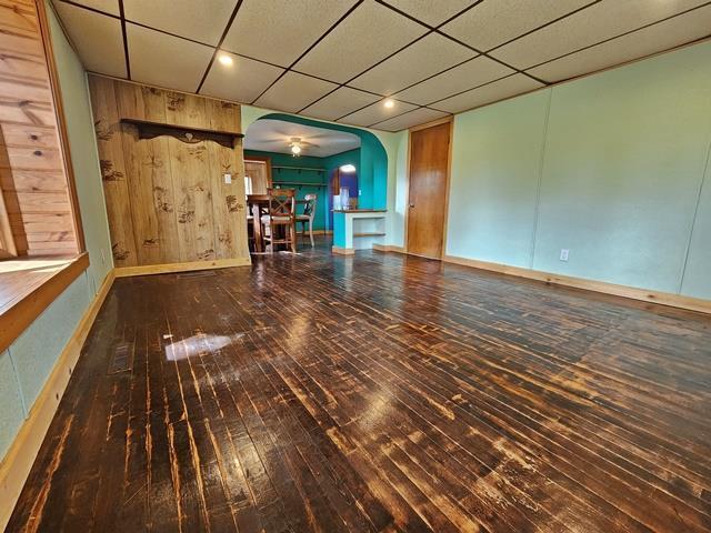5183 2nd Ave, Pittsville, WI 54466 - unfurnished living room with arched walkways, wood-type flooring, recessed lighting, and baseboards