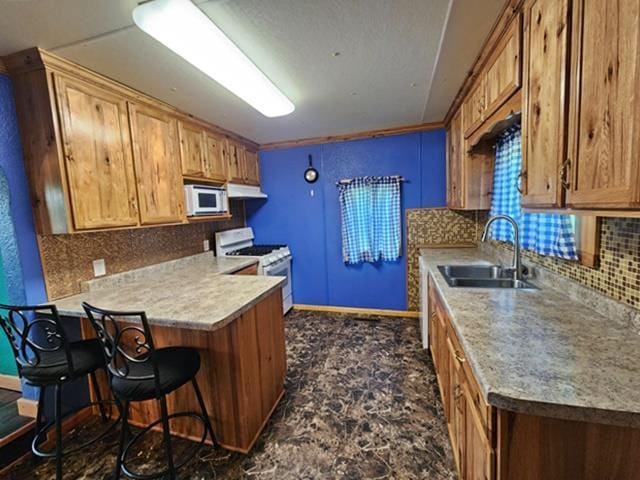 5183 2nd Ave, Pittsville, WI 54466 - kitchen with white appliances, a sink, decorative backsplash, baseboards, and a kitchen breakfast bar