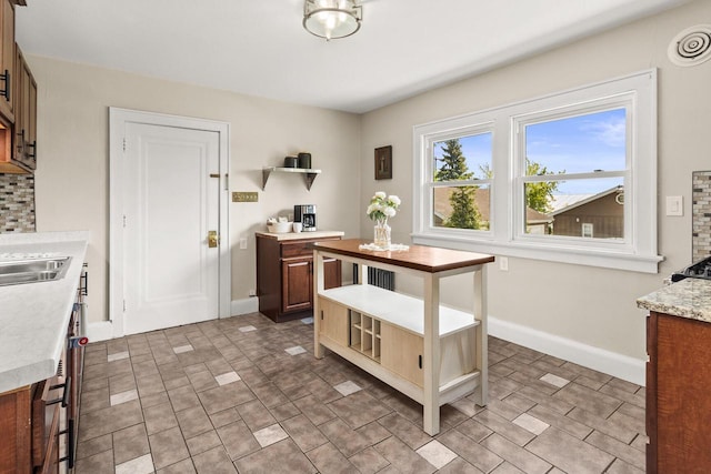 4648 S Kansas Ave Unit 4650, Saint Francis, WI 53235 - kitchen with light countertops, open shelves, and baseboards