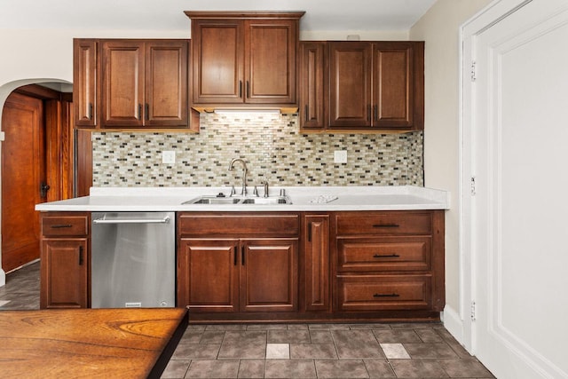 4648 S Kansas Ave Unit 4650, Saint Francis, WI 53235 - kitchen featuring stainless steel dishwasher, a sink, arched walkways, decorative backsplash, and light countertops