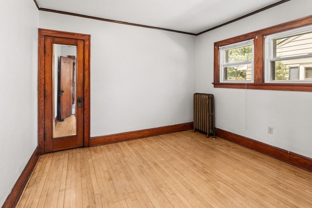 4648 S Kansas Ave Unit 4650, Saint Francis, WI 53235 - unfurnished room with radiator heating unit, crown molding, baseboards, and light wood-style flooring