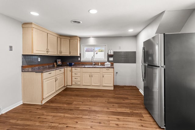 4648 S Kansas Ave Unit 4650, Saint Francis, WI 53235 - kitchen featuring freestanding refrigerator, dark countertops, light brown cabinetry, backsplash, and recessed lighting
