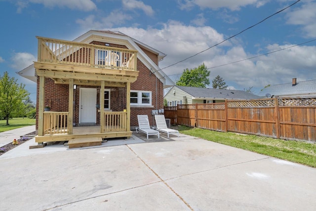 4648 S Kansas Ave Unit 4650, Saint Francis, WI 53235 - rear view of property with brick siding, a patio, and a balcony